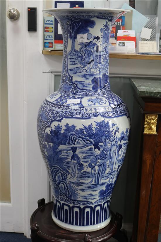 A massive Chinese blue and white vase and wood stand